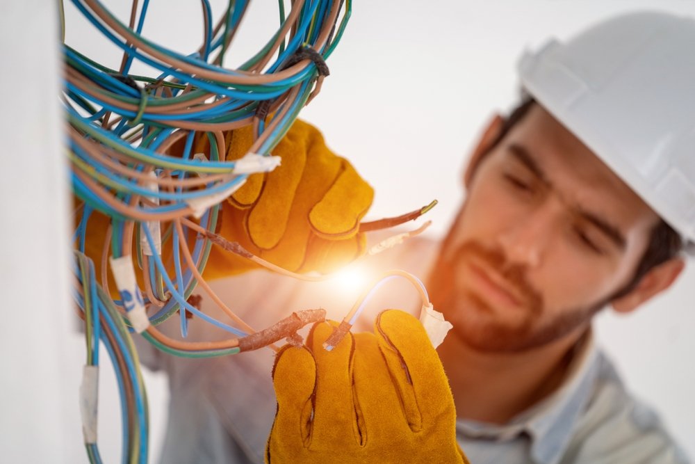 Electrician,Working,With,Cable,On,The,Construction,Site,house,And,House